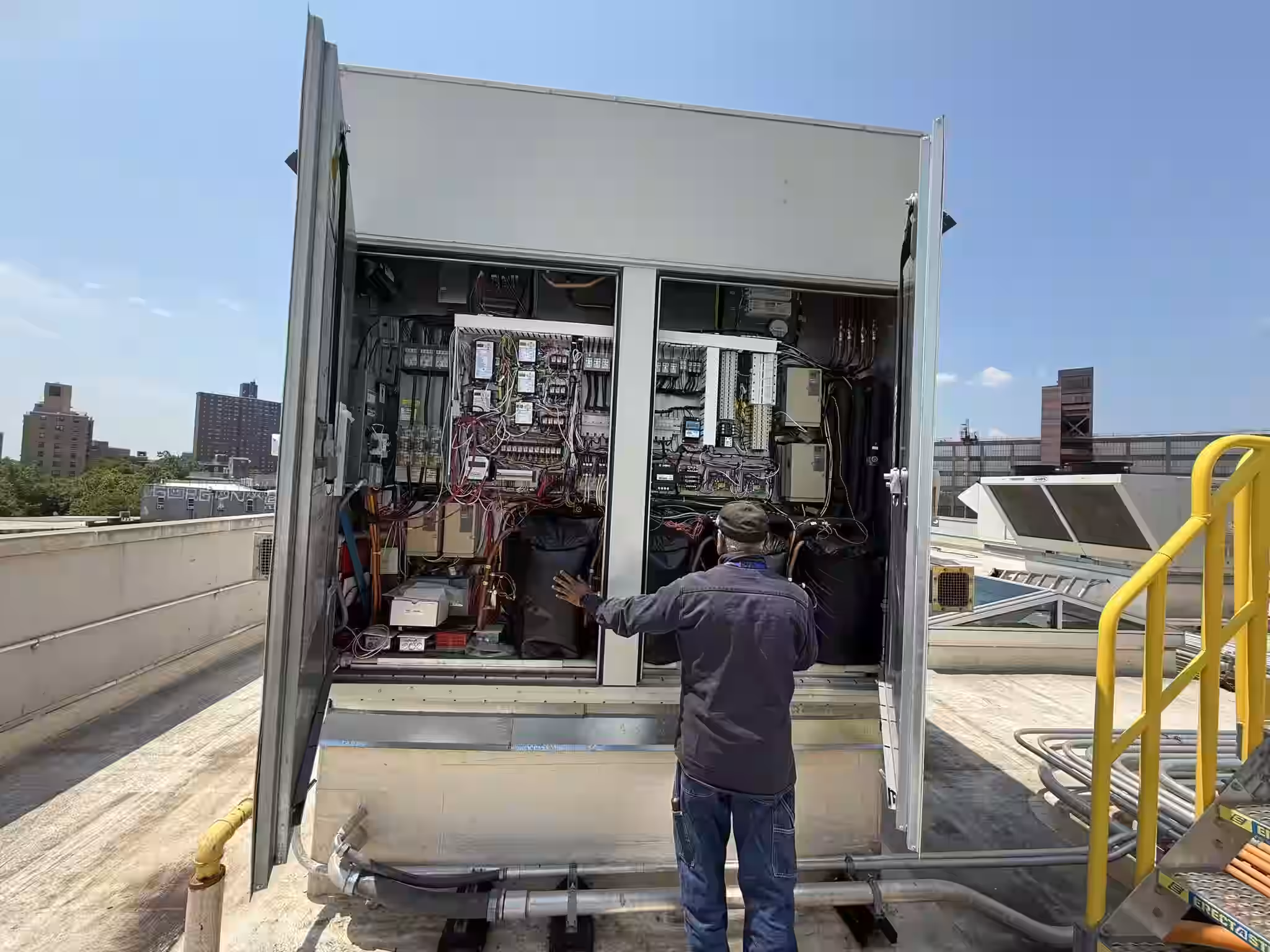 Denair HVAC technician performing preventive maintenance on commercial rooftop unit in NYC